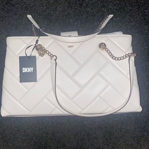 Brand new never used DKNY purse. Cream color with chain gold straps.